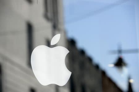 An Apple logo is seen in the window of an authorised apple reseller store in Galway, Ireland August 30, 2016. REUTERS/Clodagh Kilcoyne