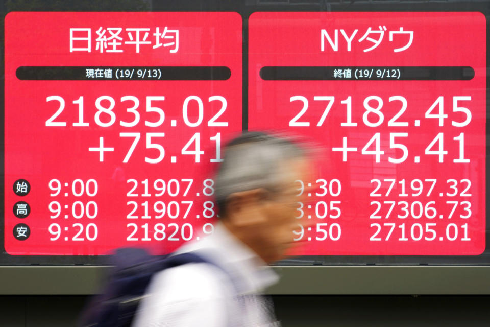 A man walks past an electronic stock board showing Japan's Nikkei 225 index at a securities firm in Tokyo Friday, Sept. 13, 2019. Stocks were broadly higher in Asia on Friday after gains overnight on Wall Street. Investors have stepped up buying on hopes for an easing of tensions in the costly trade war between the U.S. (AP Photo/Eugene Hoshiko)