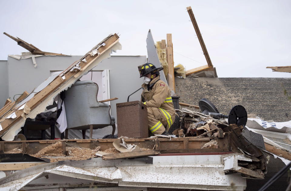 <p>An Ottawa firefighter looks for resident’s personal items in a home damaged by a tornado in Dunrobin, Ont., west of Ottawa, on Sunday, Sept. 23, 2018. The storm tore roofs off of homes, overturned cars and felled power lines in the Ottawa community of Dunrobin and in Gatineau, Que. (Photo from Justin Tang/The Canadian Press) </p>