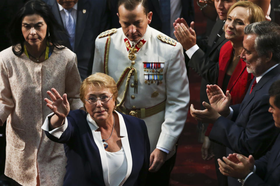FILE- In this March 11, 2018, file photo, Chile's outgoing President Michelle Bachelet waves after the swearing-in ceremony for Sebastian Pinera at Congress in Valparaiso, Chile. The U.N. General Assembly on Friday, Aug. 10, 2018, approved Bachelet as the next U.N. human rights chief by consensus. (AP Photo/Esteban Felix, File)