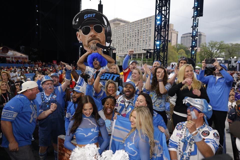 Detroit Lions fans react to their teams selection in the second round of the NFL draft at Union Station on April 28, 2023 in Kansas City, Missouri.