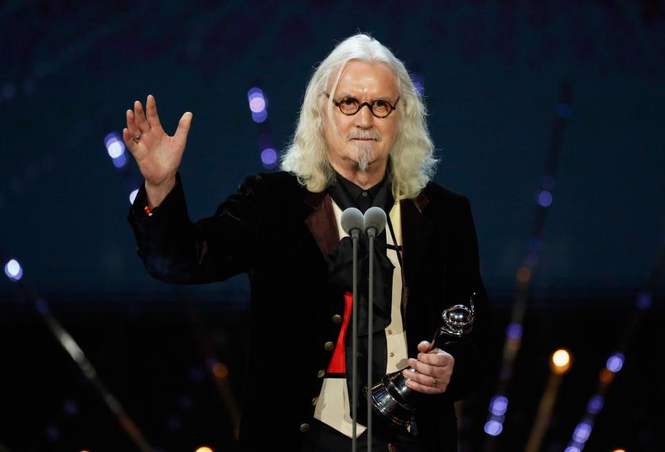 Billy Connolly will return to television to front a new ITV documentary series about his travels in America, despite his Parkinson’s disease forcing him to retire from stand-up comedy last year.According to The Sun, the beloved comic will host Billy Connolly’s Great American Trail, which will follow him as he replicates the route taken by Scottish immigrants who came to America in the early 18th century.A source told the newspaper, “Billy admitted earlier this year that Parkinson’s was taking its toll and he could no longer cope with live performances. But after ITV producers offered him a new adventure in the US, where he has spent half his life living, he decided it was too good to miss.”Earlier this year Connolly appeared on the BBC documentary series Made in Scotland, where he talked about his experiences since being diagnosed with the degenerative disease. “My life, it’s slipping away and I can feel it and I should,” he said. “I’m near the end. I’m a damn sight nearer the end than I am the beginning. But it doesn’t frighten me, it’s an adventure and it is quite interesting to see myself slipping away.”Billy Connolly’s Great American Trail will reportedly be broadcast this autumn.