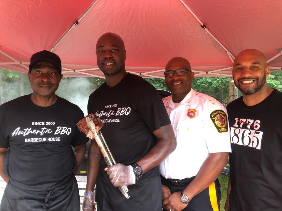 Passaic County Commissioner T.J. Best, right, stands with Donald Dickson, left, co-owner of Authentic BBQ; Alwin Dickson, a sergeant with the Passaic County Sheriff's Office and co-owner of Authentic BBQ; and Passaic County Undersheriff Kevin Dickson at the Juneteenth Freedom Day Event at Garret Mountain Reservation in Woodland Park. June 18, 2022.