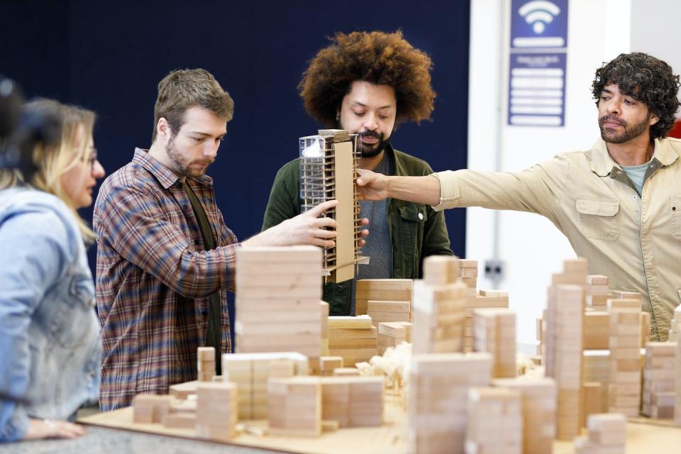 Cities around the world are exploring ways to get children and young people interested in urban planning. <a href="https://www.gettyimages.com/detail/photo/professor-handing-a-polished-building-model-to-the-royalty-free-image/1415644484" rel="nofollow noopener" target="_blank" data-ylk="slk:Capuski/E+ via Getty Images;elm:context_link;itc:0;sec:content-canvas" class="link ">Capuski/E+ via Getty Images</a>