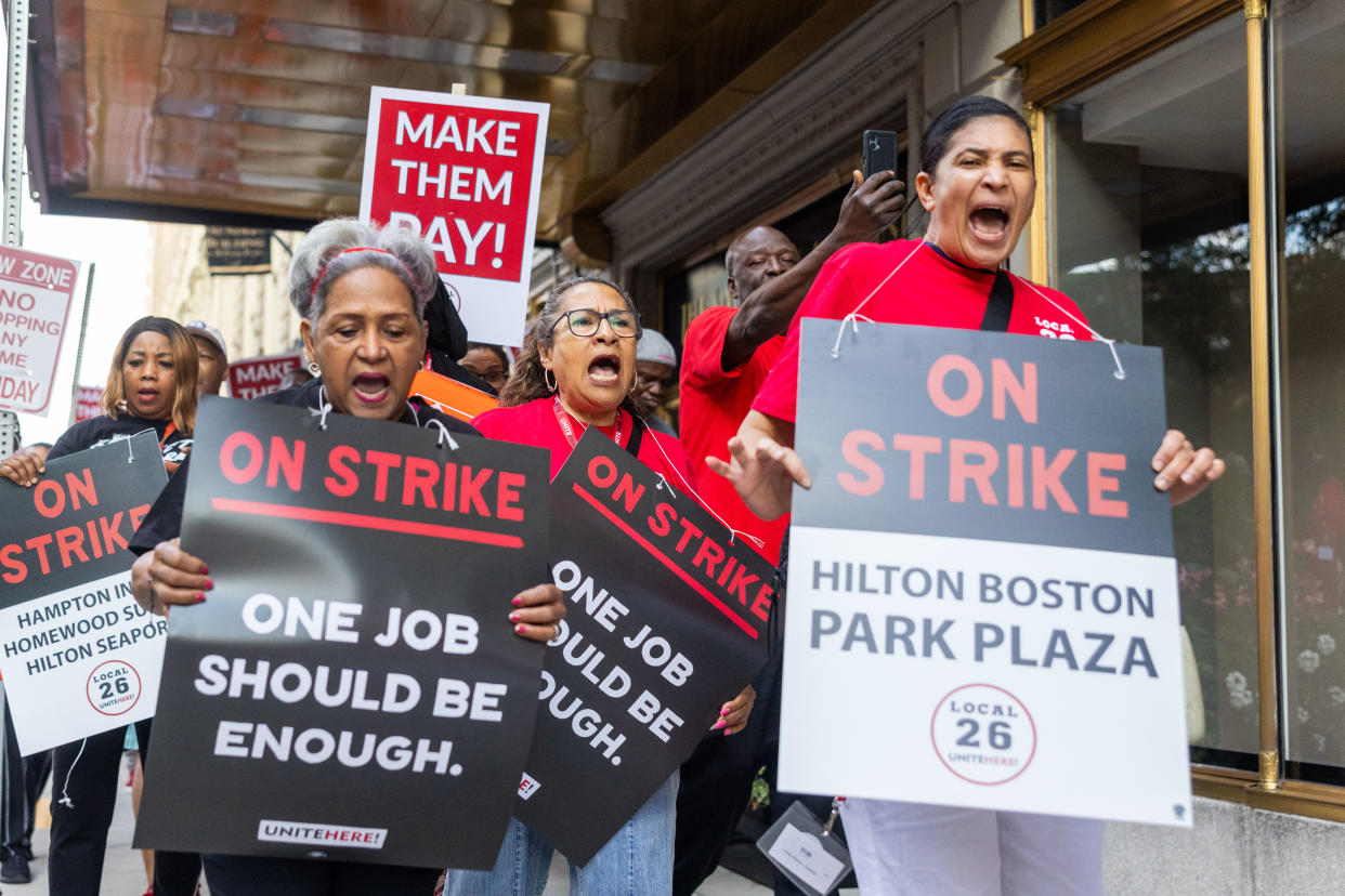 Hotel workers rally and picket holding 