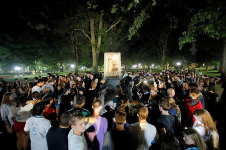 FILE PHOTO: Students and protesters surround plinth where the toppled statue of a Confederate soldier nicknamed Silent Sam once stood, on the University of North Carolina campus after a demonstration for its removal in Chapel Hill, North Carolina, U.S. August 20, 2018. REUTERS/Jonathan Drake