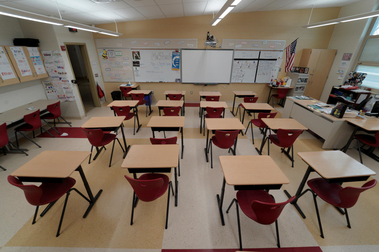 Rows of desks in an empty classroom.