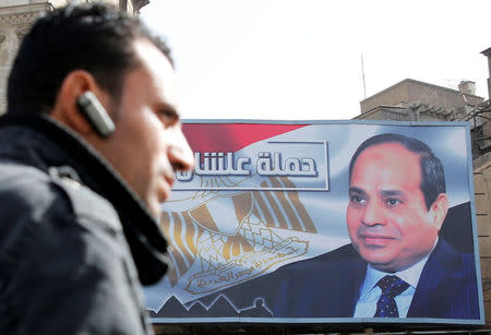 A man walks by a poster of Egypt's President Abdel Fattah al-Sisi from the campaign titled “Alashan Tabneeha” (So You Can Build It), for the upcoming presidential election in Cairo, Egypt, January 22, 2018. REUTERS/Amr Abdallah Dalsh