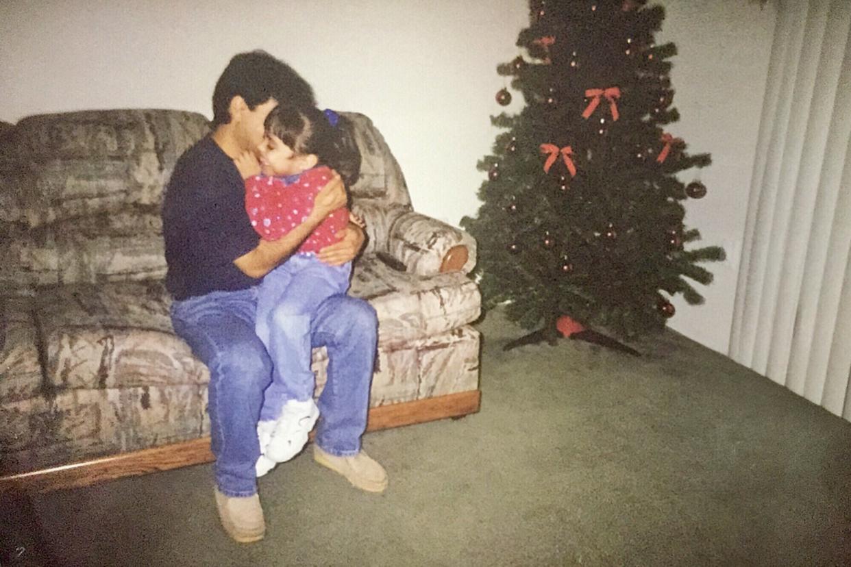 Karla Perez, as a child, with her dad&nbsp;at Christmastime. (Photo: Courtesy of Karla Perez)