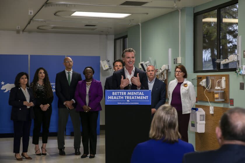 Gov. Gavin Newsom, at podium, speaks at a news conference announcing a proposed a 2024 ballot initiative to improve mental health services across the state, at Alvarado Hospital in San Diego, Sunday, March 19, 2023. (Adriana Heldiz/The San Diego Union-Tribune via AP, Pool)