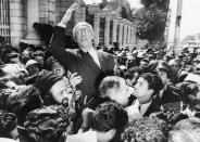 FILE - Prime Minister Mohammad Mosaddegh rides on the shoulders of cheering crowds in Tehran's Majlis Square, outside the parliament building, after reiterating his oil nationalization views to his supporters on Sept. 27, 1951. In August 1953, a CIA-backed coup toppled Iran's prime minister, cementing the rule of Shah Mohammad Reza Pahlavi for over 25 years before the 1979 Islamic Revolution. (AP Photo, File)