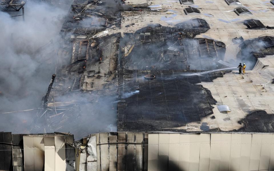 Firefighters work at the site of the Odesa strike, June 24