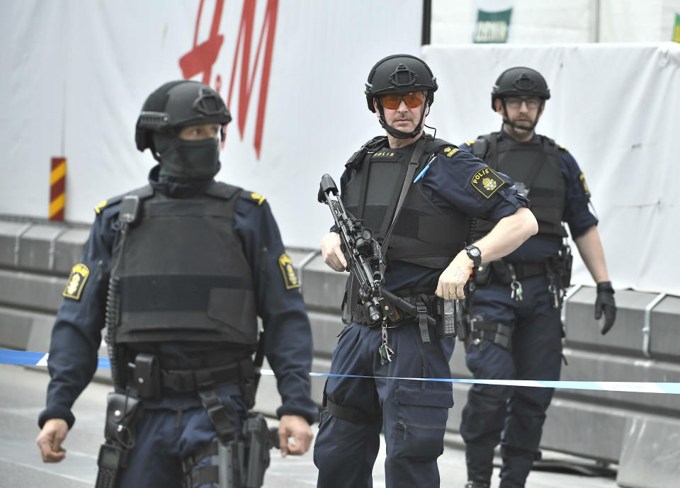 Armed police attend the scene after a truck crashed into a department store injuring several people in central Stockholm, Sweden, Friday April 7, 2017. Swedish Prime Minister Stefan Lofven says everything indicates a truck that has crashed into a major department store in downtown Stockholm is "a terror attack." (Claudio Brescian/TT News Agency via AP)