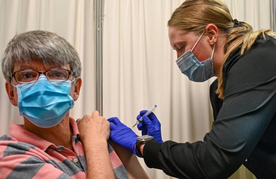 Christopher Hamilton received his first dose of the Pfizer COVID-19 vaccine from Jennifer Raasch on Thursday at the Platte County Health Department clinic in Parkville, Missouri.