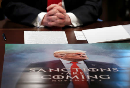 A poster of U.S. President Donald Trump is seen on the table during a Cabinet meeting on day 12 of the partial U.S. government shutdown at the White House in Washington, U.S., January 2, 2019. REUTERS/Jim Young