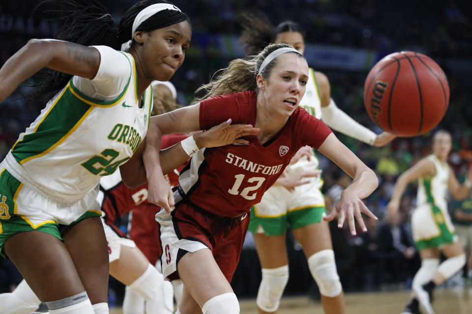 Oregon's Ruthy Hebard (24) and Stanford's Lexie Hull (12) vie for a rebound during the second half of an NCAA college basketball game in the final of the Pac-12 women's tournament Sunday, March 8, 2020, in Las Vegas. (AP Photo/John Locher)