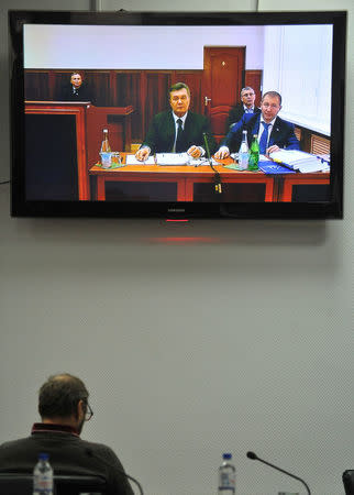 Ukraine's former President Viktor Yanukovich is seen on the screen as he comes to give evidence to a Ukrainian court via a video link, appearing as a witness in the trial of former riot police force members suspected of killing participants of the 2014 anti-government and pro-European Union mass protests, inside a building of a regional court in Rostov-on-Don, Russia, November 25, 2016. REUTERS/Sergei Pivovarov