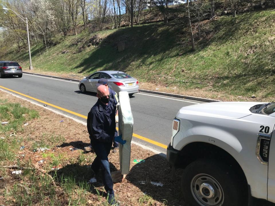 Woodland Park Mayor Keith Kazmark removes a child's mattress that had littered an on-ramp to Route 80 East for six weeks.