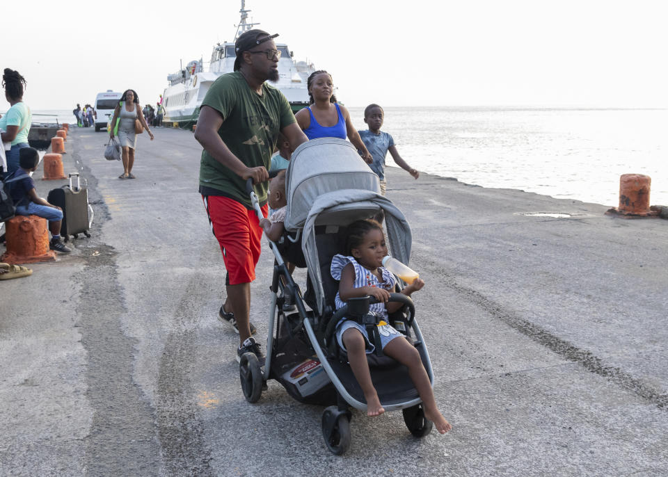 Evacuees from Union Island arrive in Kingstown, St. Vincent and the Grenadines, Tuesday, July 2, 2024. The island, in the Grenadines archipelago, was hit by Hurricane Beryl. (AP Photo/Lucanus Ollivierre)