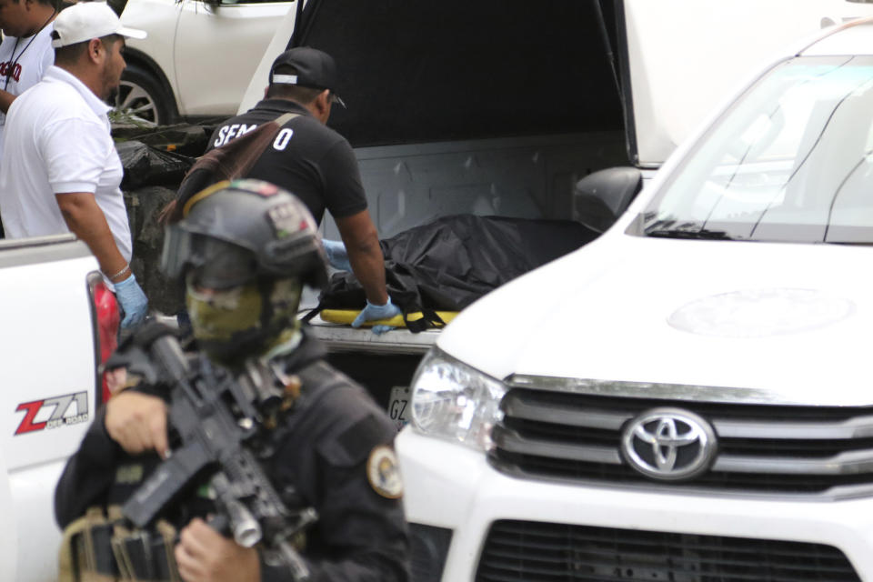 The body of Bruno Plácido, a well-known leader of a civilian "self-defense" group, is loaded into the forensic vehicle after being shot to death in Chilpancingo, Mexico, Tuesday, Oct. 17, 2023. (AP Photo/Alejandrino Gonzalez)