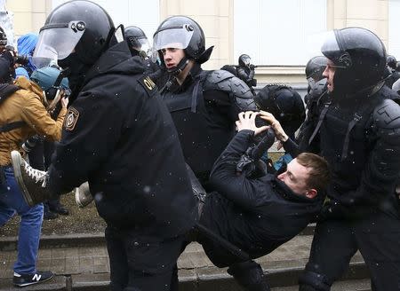 Law enforcement officers detain a man during a gathering, denouncing the new tax on those not in full-time employment and marking the 99th anniversary of the proclamation of the Belarussian People's Republic, in Minsk, Belarus, March 25, 2017. REUTERS/Vasily Fedosenko