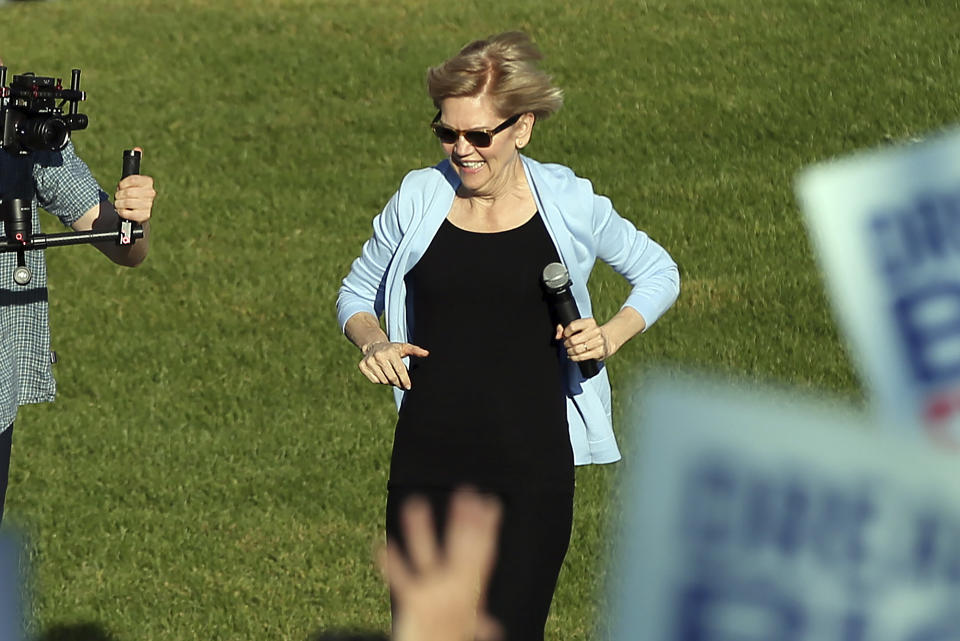 Democratic presidential candidate Elizabeth Warren, D-Mass., runs to the platform as she arrives to speak at a rally Monday, Aug. 19, 2019 at Macalaster College during a campaign appearance in St. Paul, Minn. (AP Photo/Jim Mone)