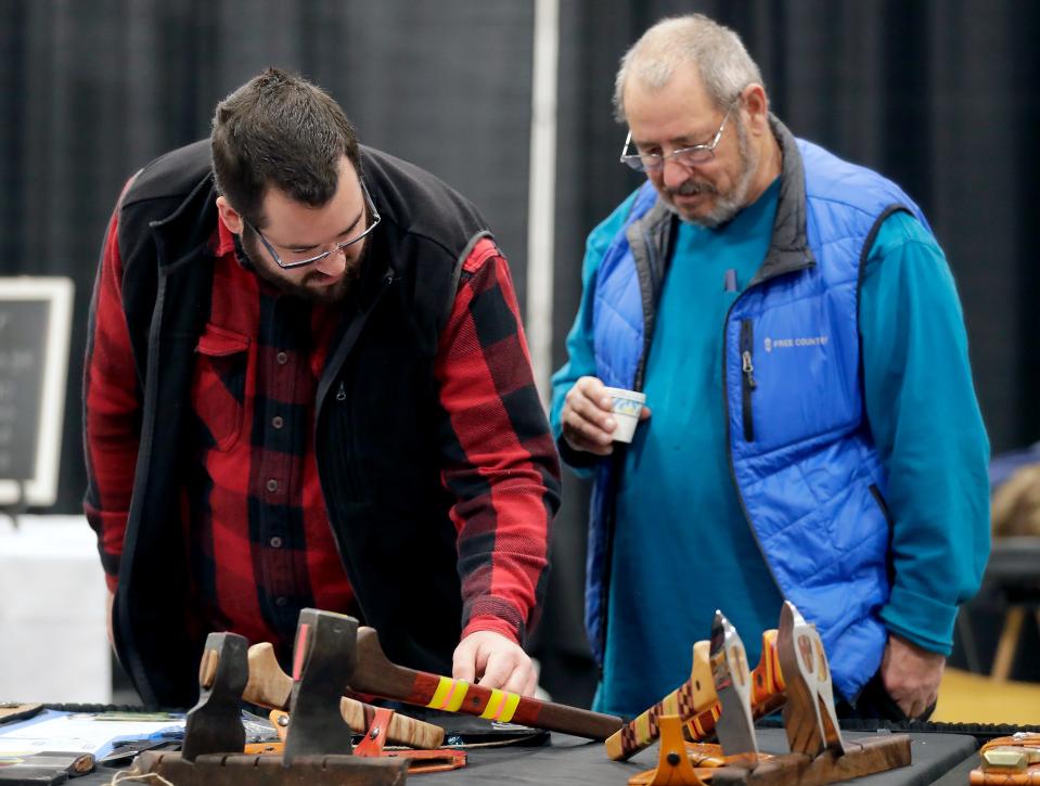 Dale Laurin Sr., right, and Cody Laurin browse during the 2022 World Axe Throwing Championships and World Knife Throwing Championships on Friday at the Fox Cities Exhibition Center in Appleton.