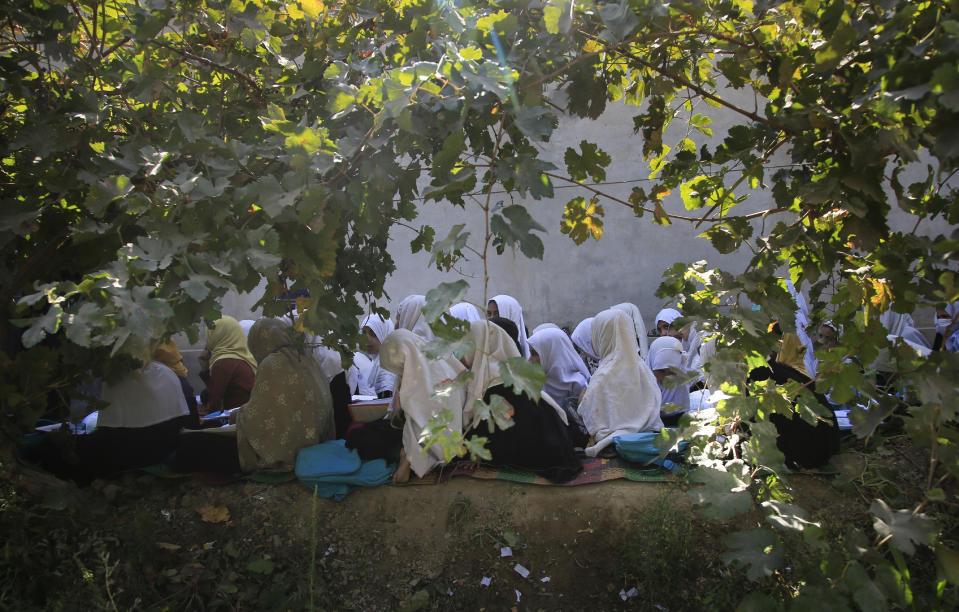 FILE - in this Wednesday, Oct. 7, 2020, Afghan students attend an open air class at a primary school in Kabul, Afghanistan, An Afghan education ministry memo banning girls, 12 years old and older, from singing at public school functions, which the education ministry tells The Associated Press was a mistake, is causing a social media stir. (AP Photo/Mariam Zuhaib, File)