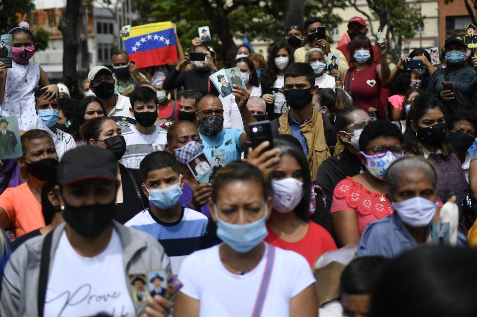 People gather outside the church associated with the remains of Venezuelan Dr. Jose Gregorio Hernandez during his geatification ceremony in Caracas, Venezuela, Friday, April 30, 2021. Known as the "doctor of the poor, Hernandez is being beatified Friday by the Catholic church, a step towards sainthood. (AP Photo/Matias Delacroix)