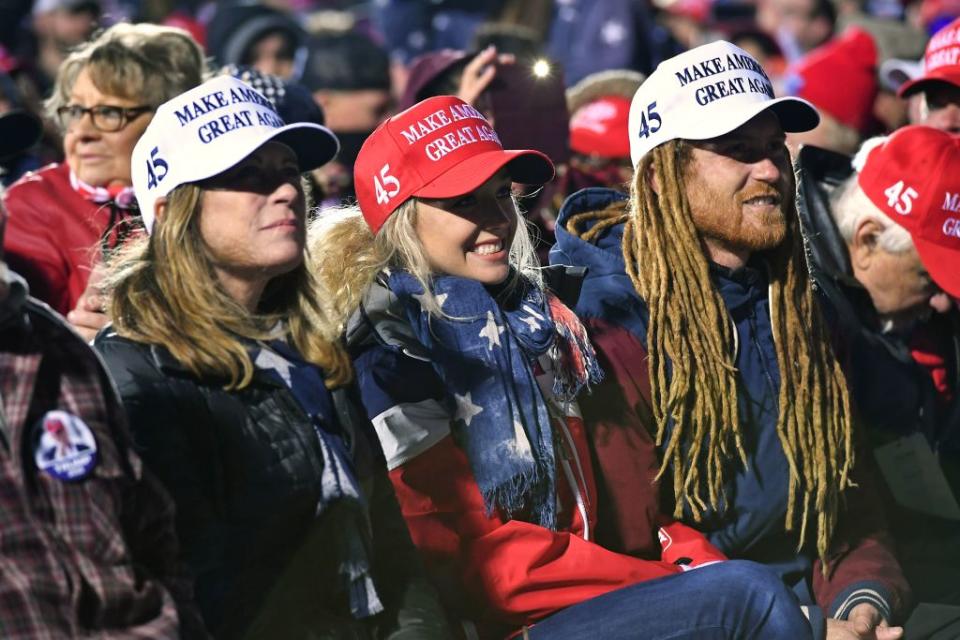 Suporters of US President Donald Trump pictured wearing MAGA hats. 