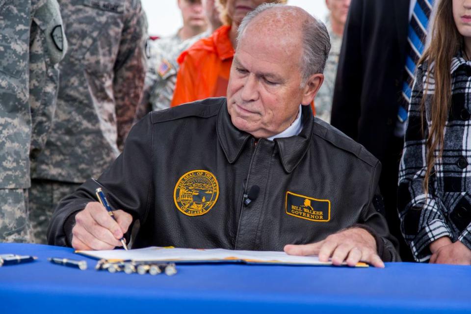 Alaska Gov. Bill Walker signs the Alaska Code of Military Justice into law during a ceremony in downtown Anchorage in 2016. Walker, an Independent, brought Medicaid expansion to his state via executive order nine years ago.