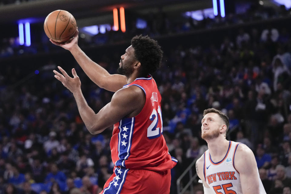 Philadelphia 76ers center Joel Embiid (21) goes to the basket past New York Knicks center Isaiah Hartenstein (55) during the first half in Game 1 of an NBA basketball first-round playoff series, Saturday, April 20, 2024, at Madison Square Garden in New York. (AP Photo/Mary Altaffer)