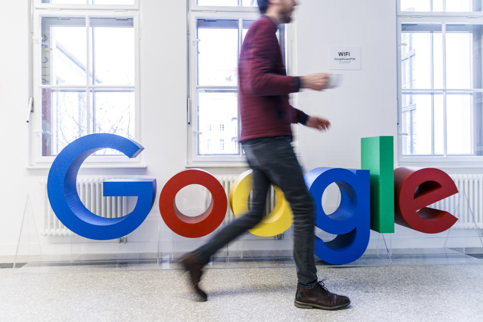 BERLIN, GERMANY - JANUARY 22: An employee passes the Google logo during the press tour before the festive opening of the Berlin representation of Google Germany on January 22, 2019 in Berlin, Germany. The official opening will take place tonight with Berlin Mayor Michael Mueller. (Photo by Carsten Koall/Getty Images)