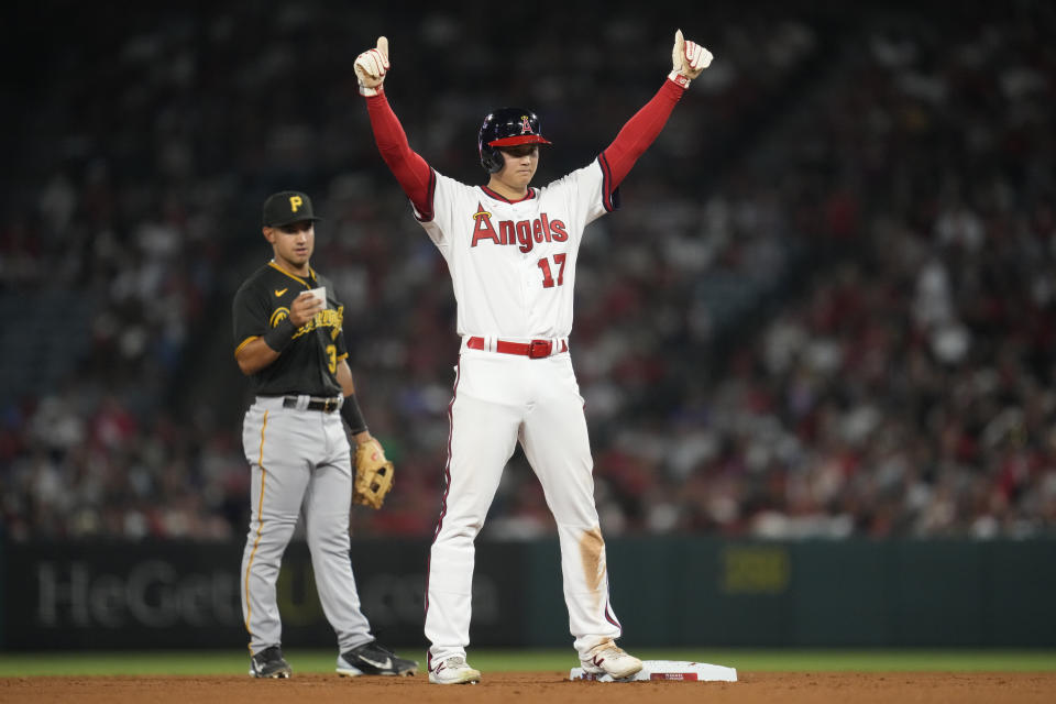 Los Angeles Angels starting pitcher Shohei Ohtani (17) gives a thumbs up after reaching second on a single hit by Mickey Moniak during the seventh inning of a baseball game against the Pittsburgh Pirates in Anaheim, Calif., Friday, July 21, 2023. (AP Photo/Ashley Landis)