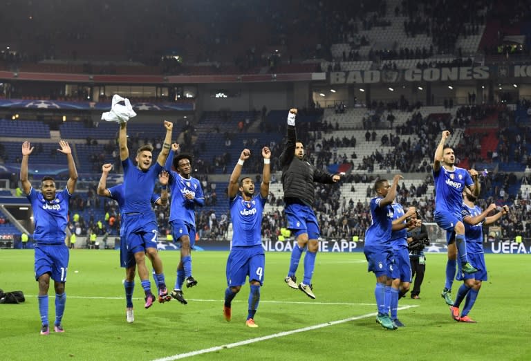 Juventus' players jubilate after winning their Champions League football match against Lyon on October 18, 2016 in Decines-Charpieu near Lyon, southeastern France