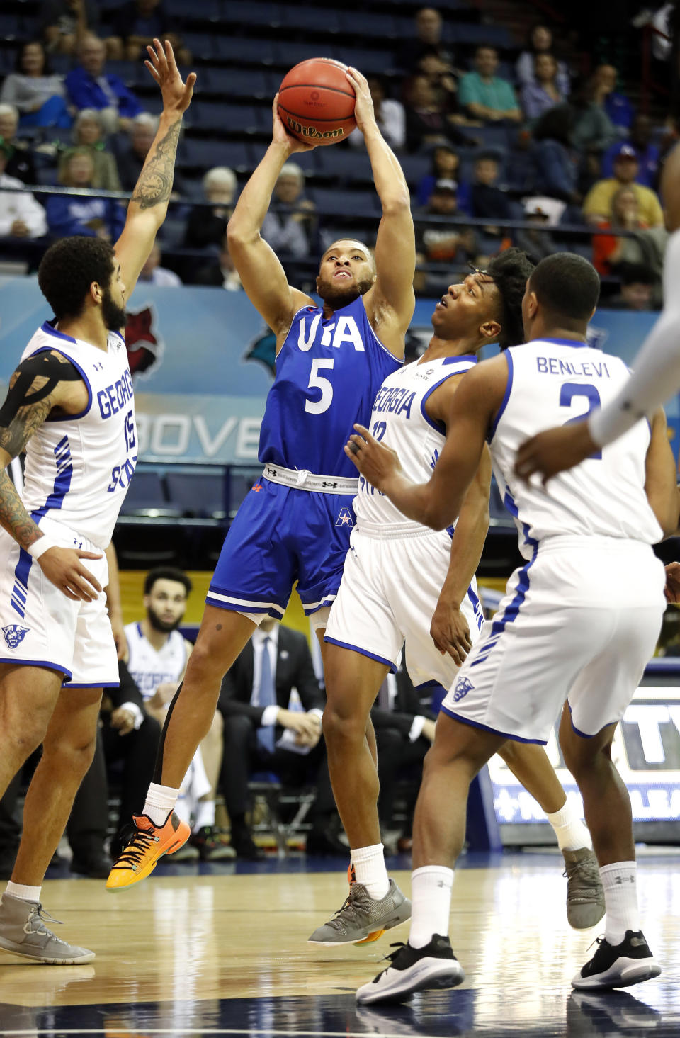 Texas-Arlington guard Edric Dennis (5) is defended by Georgia State guard D'Marcus Simonds (15) and guard Kane Williams (12) during the first half of the NCAA college basketball championship game of the Sun Belt Conference men's tournament in in New Orleans, Sunday, March 17, 2019. (AP Photo/Tyler Kaufman)