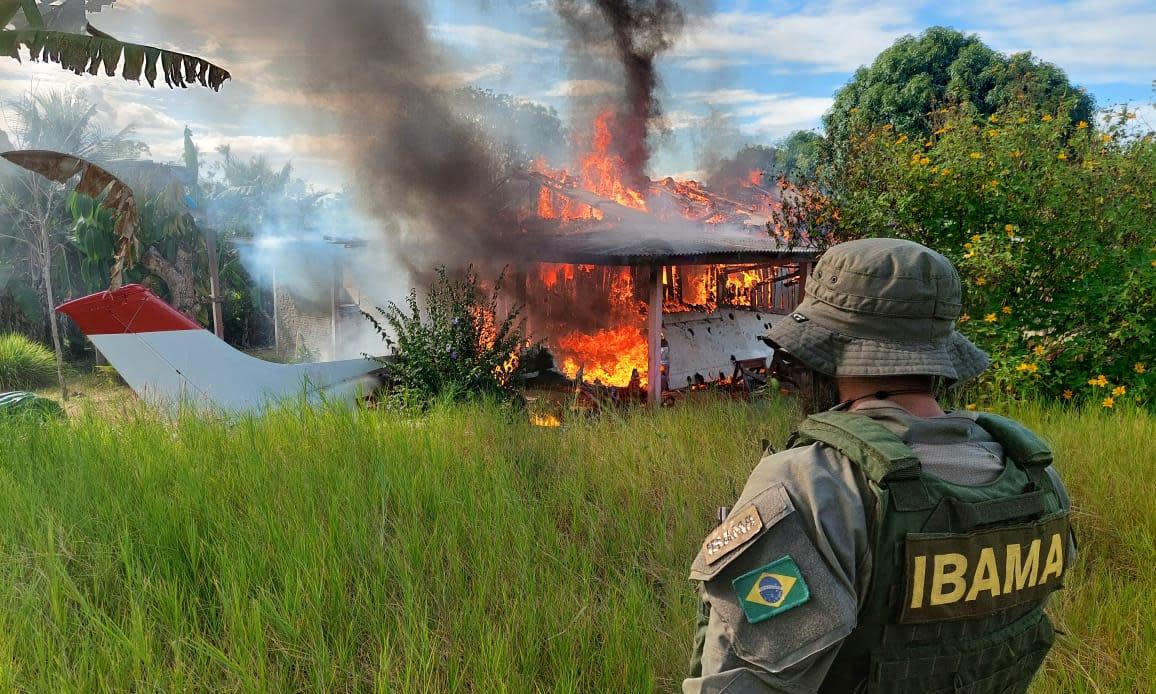 <span>An aircraft belonging to illegal miners is consumed by fire during an operation against Amazon deforestation. The ICC has been sent several formal complaints alleging serious crimes taking place in the Brazilian rainforest.</span><span>Photograph: Ibama/AFP/Getty</span>