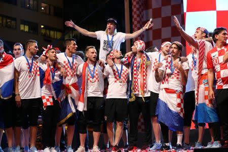 Soccer Football - World Cup - The Croatia team return from the World Cup in Russia - Zagreb, Croatia - July 16, 2018 Croatia's Ivan Rakitic, Domagoj Vida and team mates on stage during celebrations REUTERS/Antonio Bronic