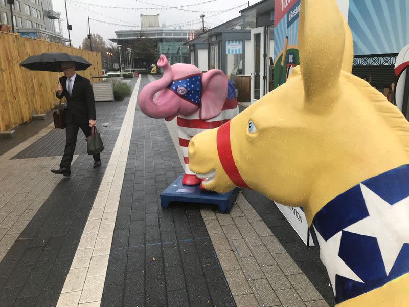 A commuter walks past U.S. political party symbols at Metro station in Reston, Virginia