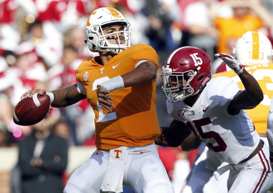 Tennessee quarterback Jarrett Guarantano (2) attempts to throw to a receiver as he is pressured by Alabama defensive back Xavier McKinney (15) in the first half of an NCAA college football game against Alabama Saturday, Oct. 20, 2018, in Knoxville, Tenn. (AP Photo/Wade Payne)