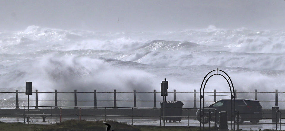 Waves crash into the seafront at Tramore in County Waterford, on the southeast coast of Ireland, Tuesday, Aug. 25, 2020. Storm Francis has brought gusts of more than 50mph overnight ahead of the wet and windy weather impacting vast swathes of the UK and Ireland on Tuesday. (Niall Carson/PA via AP)