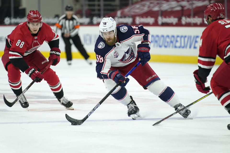 FILE - In this March 20, 2021, file photo, Columbus Blue Jackets defenseman David Savard (58) skates against Carolina Hurricanes center Martin Necas (88) during the first period of an NHL hockey game in Raleigh, N.C. The defending Stanley Cup champion Tampa Bay Lightning acquired defenseman David Savard from the Columbus Blue Jackets in a three-team trade Saturday, April 10, 2021, that also involves the Detroit Red Wings. (AP Photo/Gerry Broome, File)