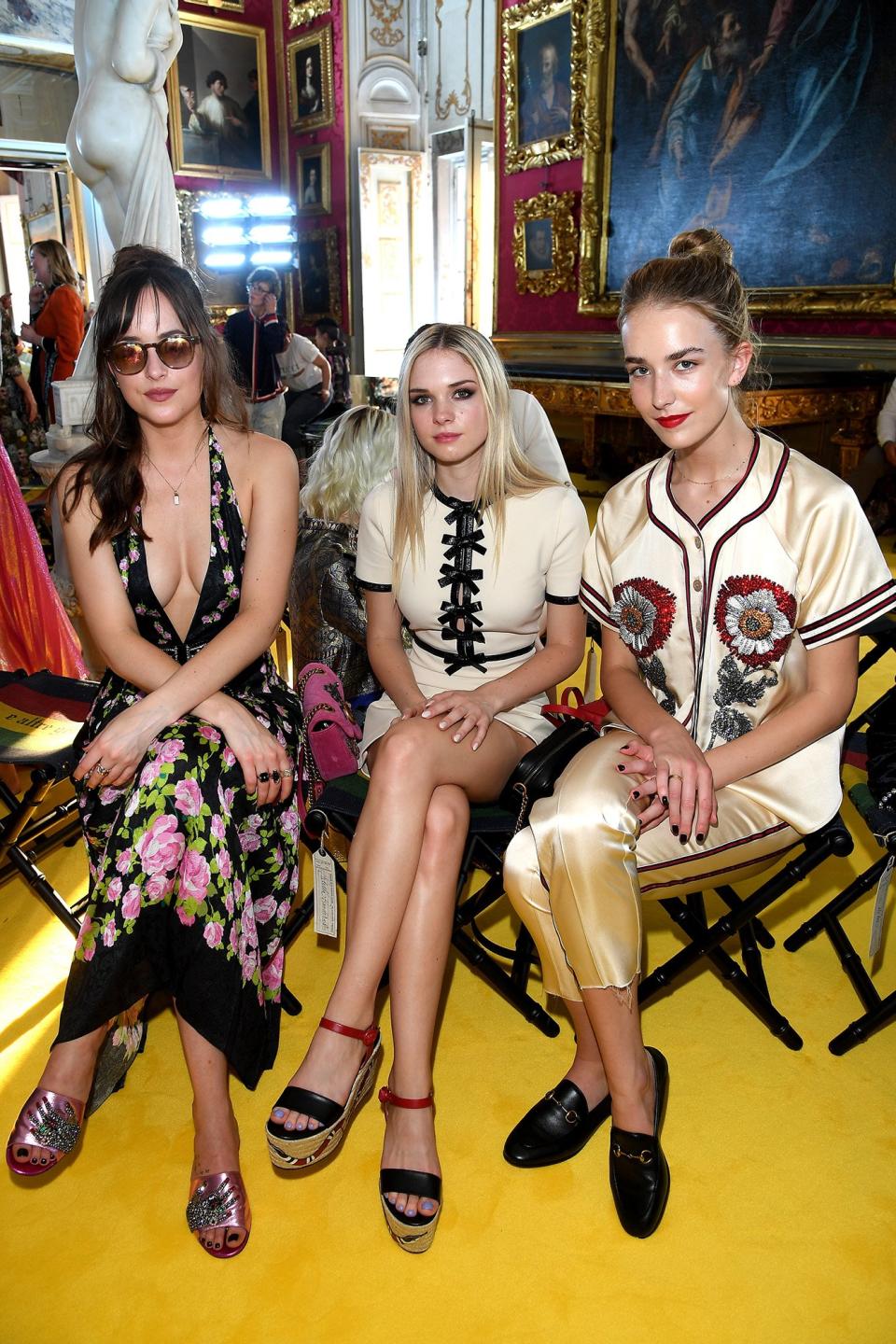 The <em>Fifty Shades Darker</em> actress sat front row at the Gucci Cruise show in Florence, Italy with her two half-sisters: Stella Banderas-Griffith — daughter of Johnson's mom Melanie Griffith and her ex-husband Antonio Banderas — and Grace Johnson — daughter of Johnson's dad Don Johnson and his current wife Kelley Phleger. There may be four different parents among the three, but it's clear that good looks run in the <em>entire</em> family.