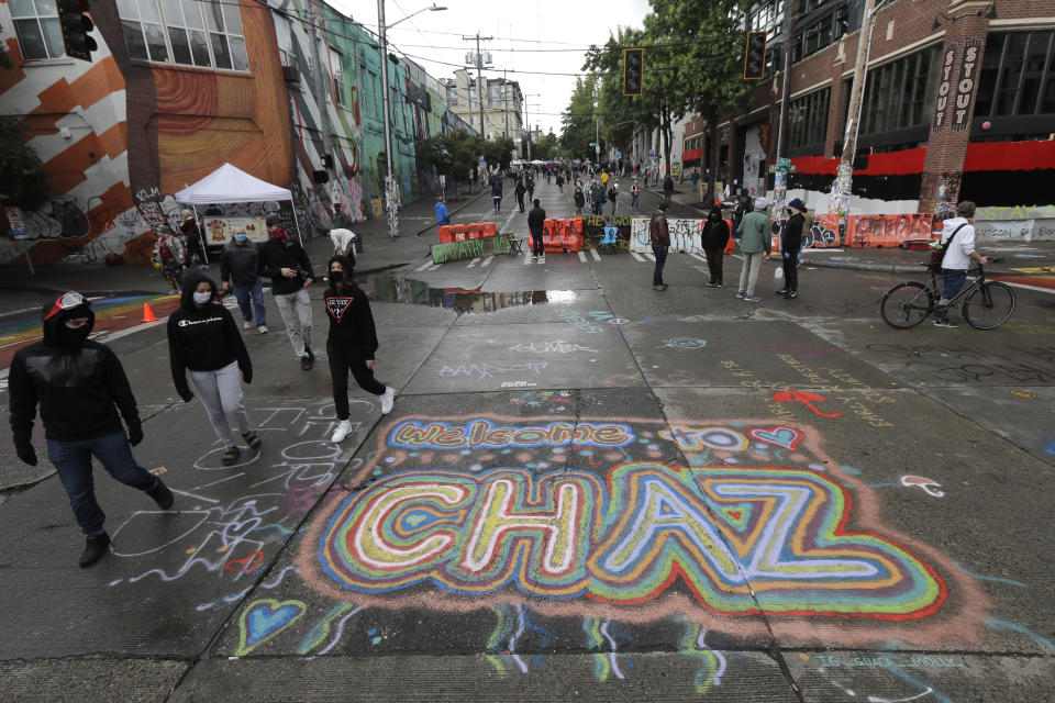 Sreet art reads "Welcome to CHAZ" on Thursday inside what is being called the Capitol Hill Autonomous Zone in Seattle. Following days of violent confrontations with protesters, police in Seattle have largely withdrawn from the neighborhood, and protesters have created a festival-like scene that has President Donald Trump fuming. (Photo: Ted S. Warren/ASSOCIATED PRESS)