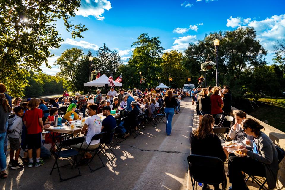 Community members gather for dinner at the Washington Street Bridge in Muncie in 2022.