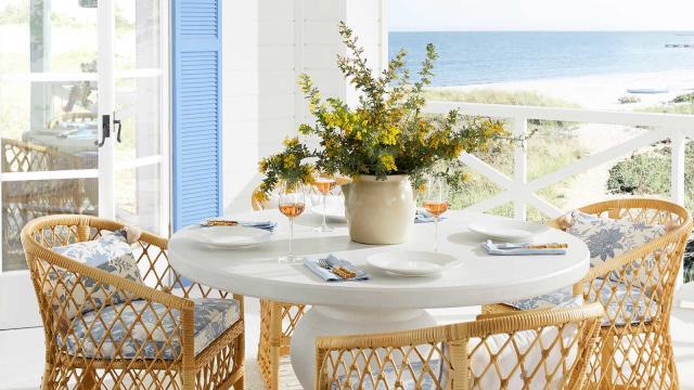  outdoor dining table with vase of flowers 