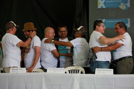 Revolutionary Armed Forces of Colombia (FARC) commander Ivan Marquez and members of the leadership congratulate each other after a news conference at the camp where they prepare to ratify a peace deal with the Colombian government, near El Diamante in Yari Plains, Colombia, September 23, 2016. REUTERS/John Vizcaino