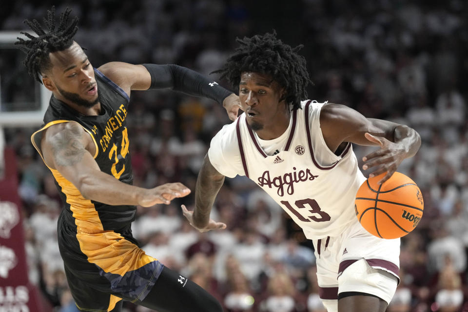 Texas A&M forward Solomon Washington (13) has the ball knocked away by Texas A&M Commerce forward Jerome Brewer Jr. (24) during the first half of an NCAA college basketball game Monday, Nov. 6, 2023, in College Station, Texas. (AP Photo/Sam Craft)