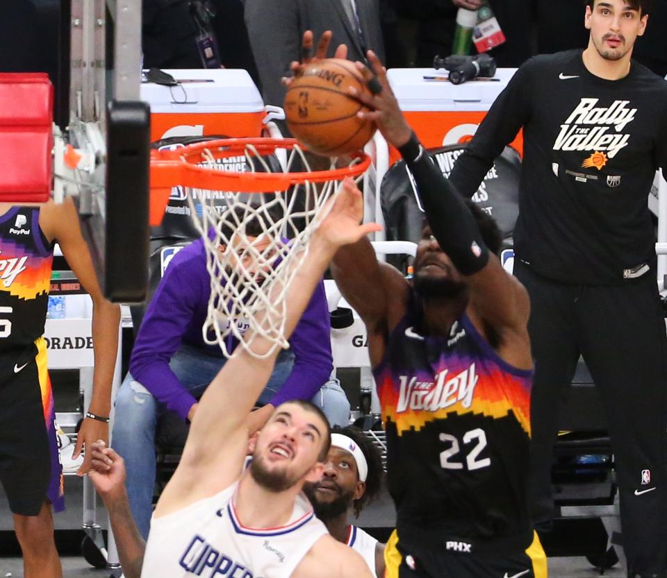 Jun 22, 2021; Phoenix, Arizona, U.S; Phoenix Suns center Deandre Ayton (22) grabs a lob over LA Clippers center Ivica Zubac (40) for the game-winning basket with .7 seconds remaining during Game 2 at Phoenix Suns Arena on June 22, 2021.