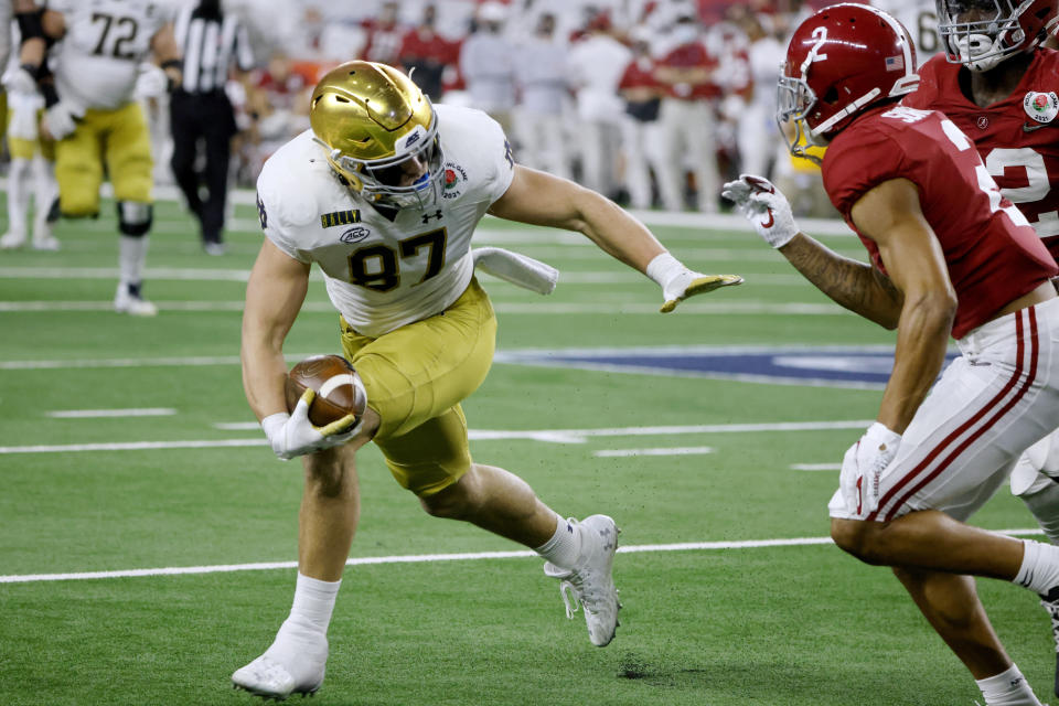 FILE - In this Jan. 1, 2021, file photo, Notre Dame tight end Michael Mayer (87) gains yardage after a catch as Alabama defensive back Patrick Surtain II (2) moves in to make the stop in the second half of the Rose Bowl NCAA college football game in Arlington, Texas. Offensive coordinator Tommy Rees has seen the offense come together behind quarterback Jack Coan, a grad transfer from Wisconsin, and preseason All-American candidates in running back Kyren Williams, tight end Michael Mayer, center Jarrett Patterson and guard Cain Madden, another grad transfer. (AP Photo/Michael Ainsworth, File)